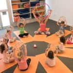 kids in circle with breathing balls and yoga teacher