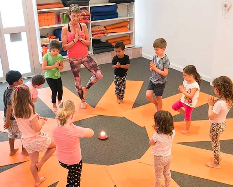 early learning yoga class kids in tree pose