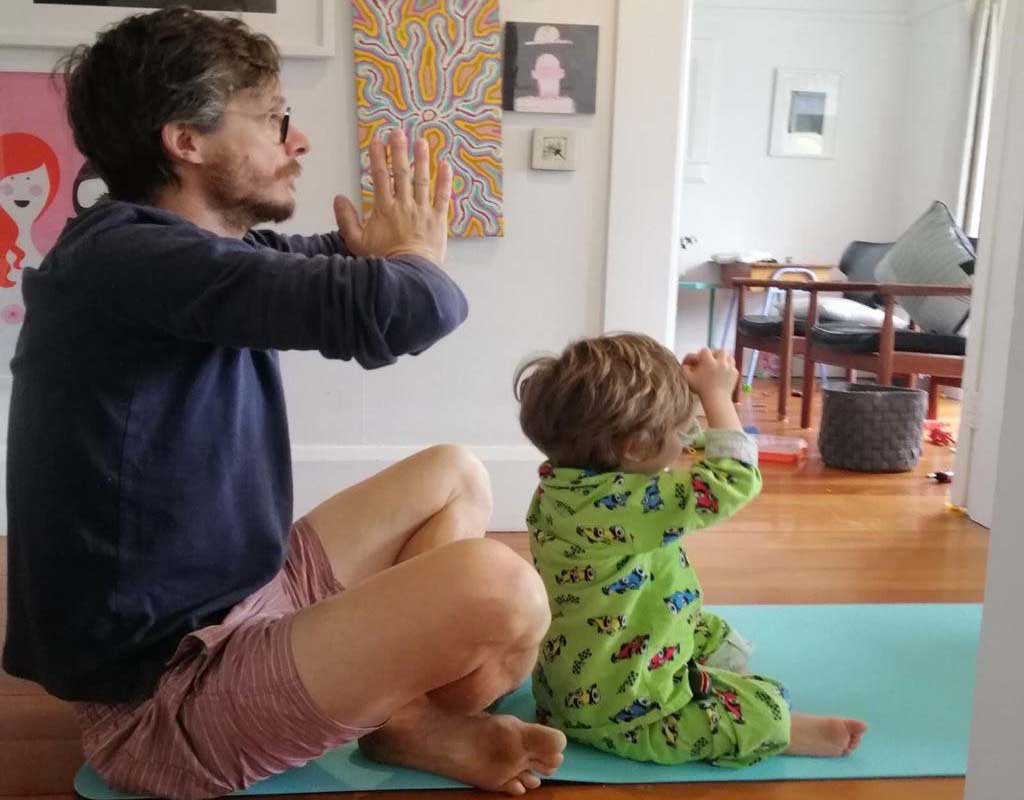 yoga lesson in homeschool dad and child