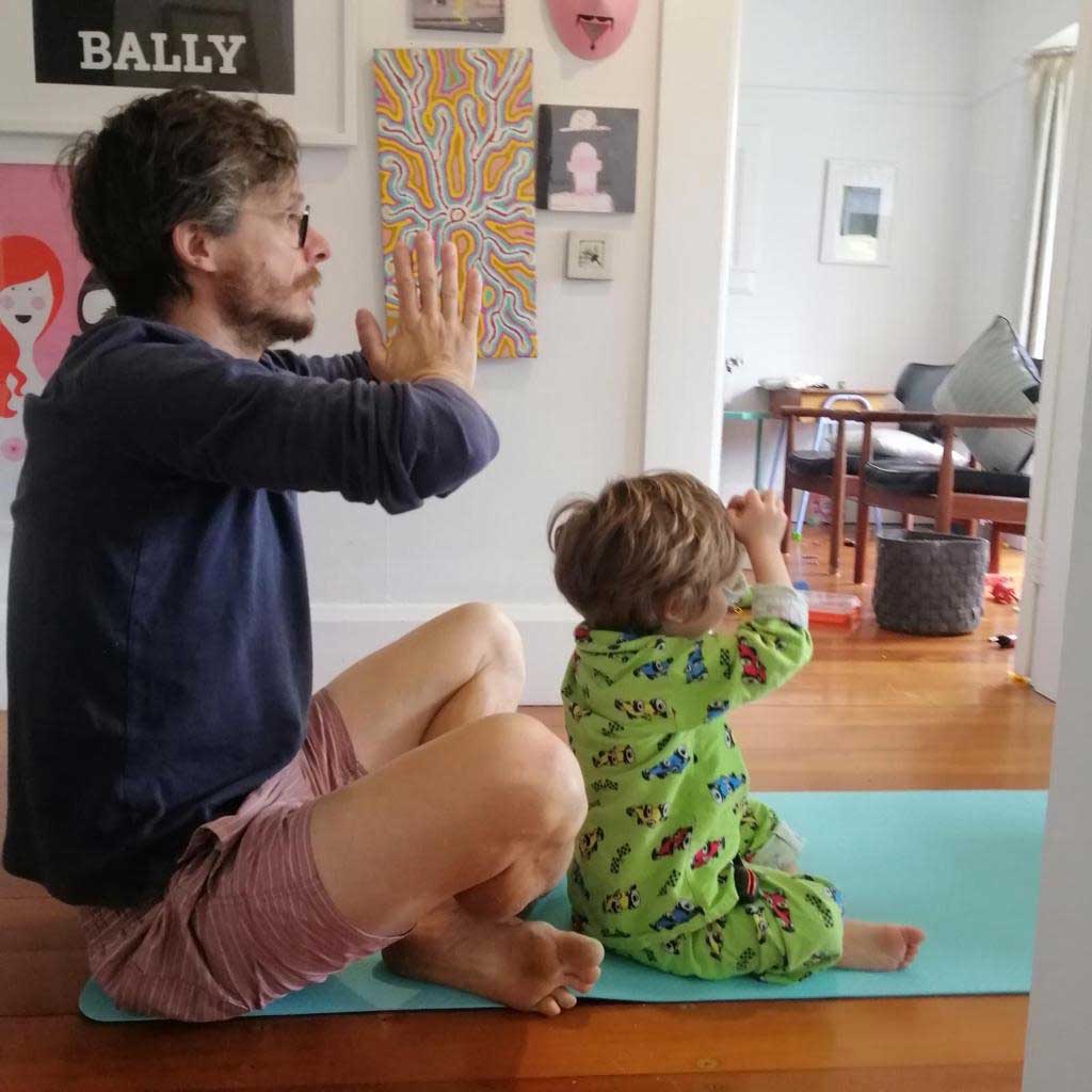 dad with homeschooler in yoga lesson