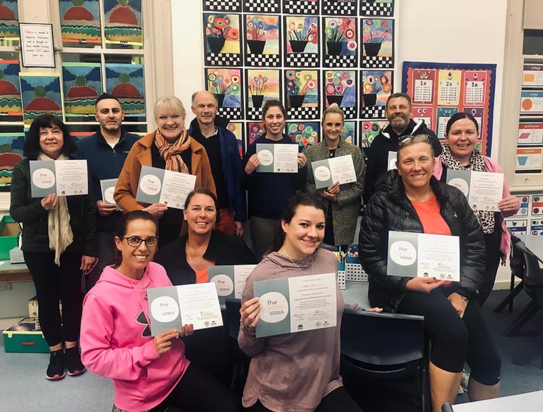 teachers holding certificates after completing yoga course for NESA