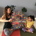 daycare little girl with yoga instructor and breathing ball