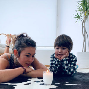 little boy and yoga teacher watching a candle