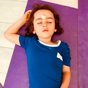 girl with stone on forehead in resting pose