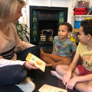 mum with boys showing the karma class cards